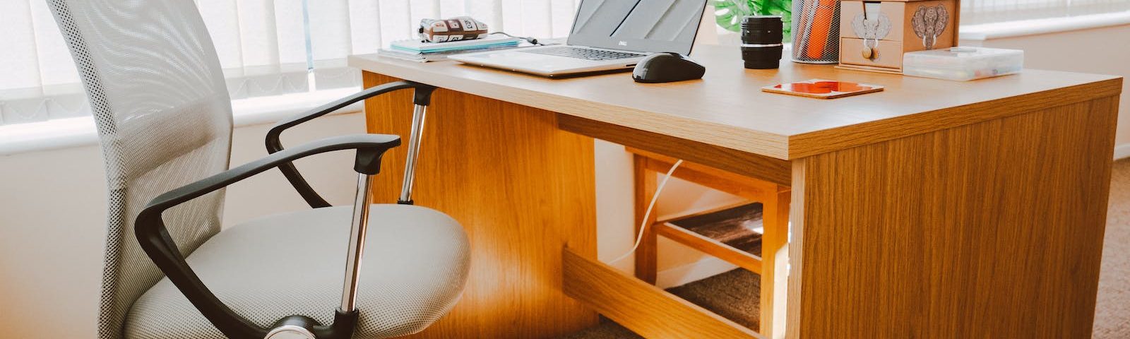 White Rolling Armchair Beside Table