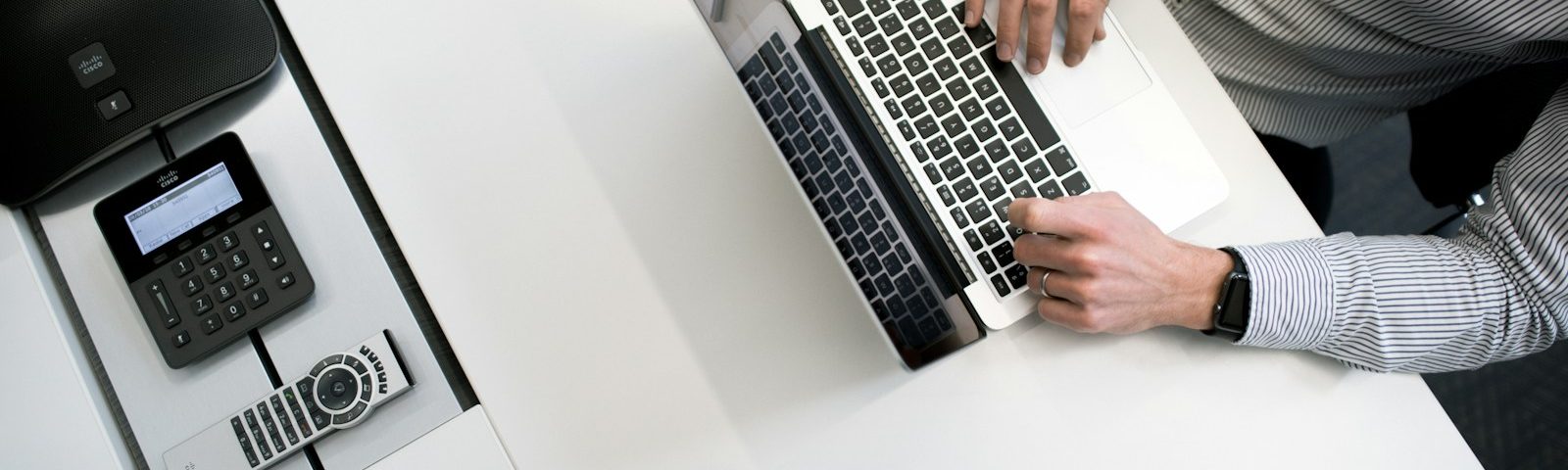 person using laptop on white wooden table