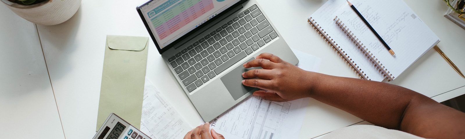 a person sitting at a table with a laptop